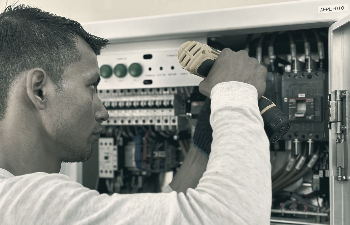 Electrician at work in a switchboard
